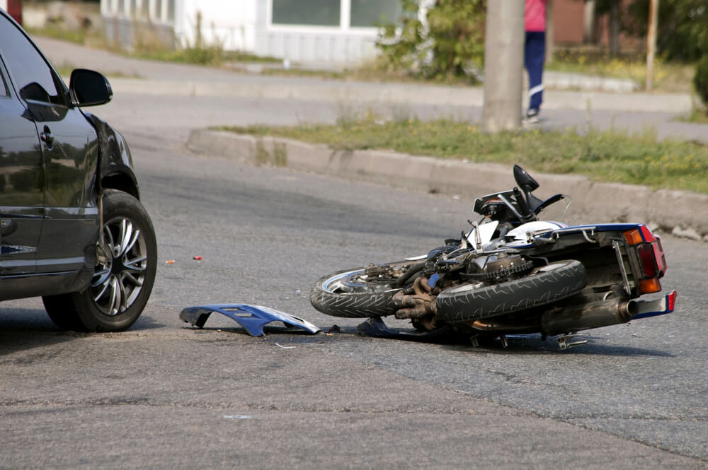 motorcycle fallen over on the road after an accident