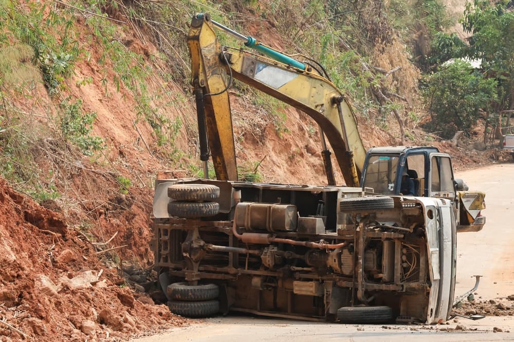 A dump truck that had an accident In the construction area, roads are being pushed with excavators