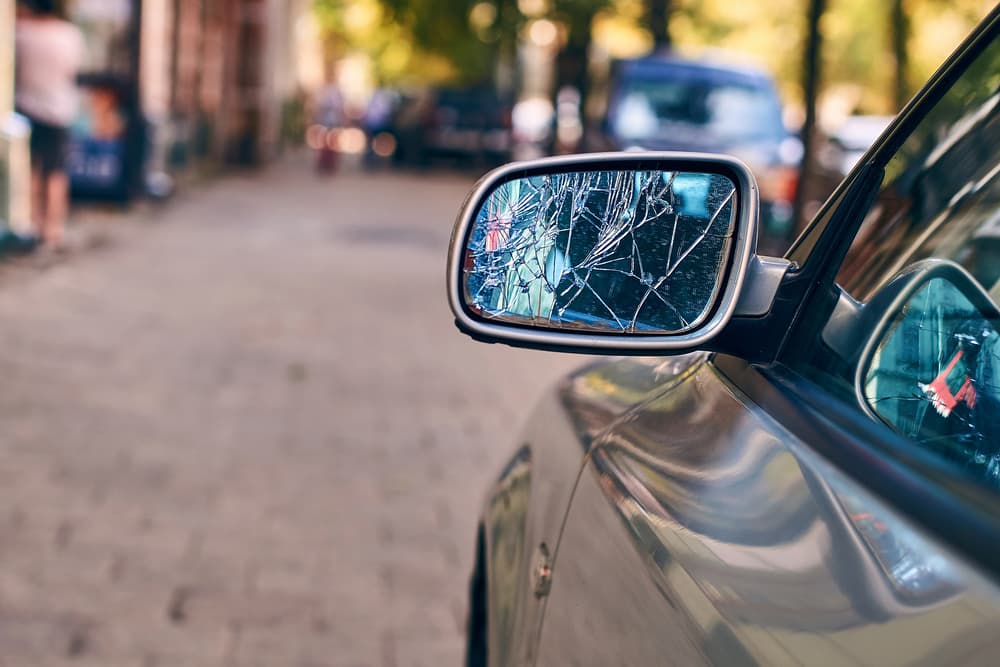 Car with broken side door mirror